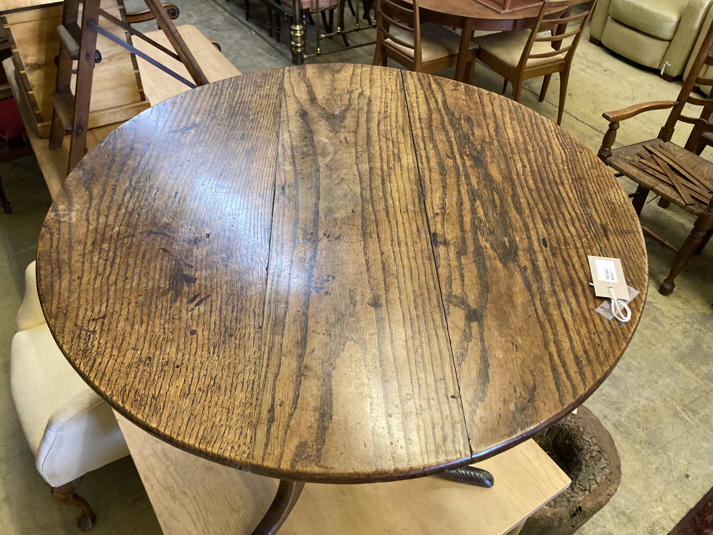 A George III circular oak tea table on tripod base, height 68cm, 78cm diameter